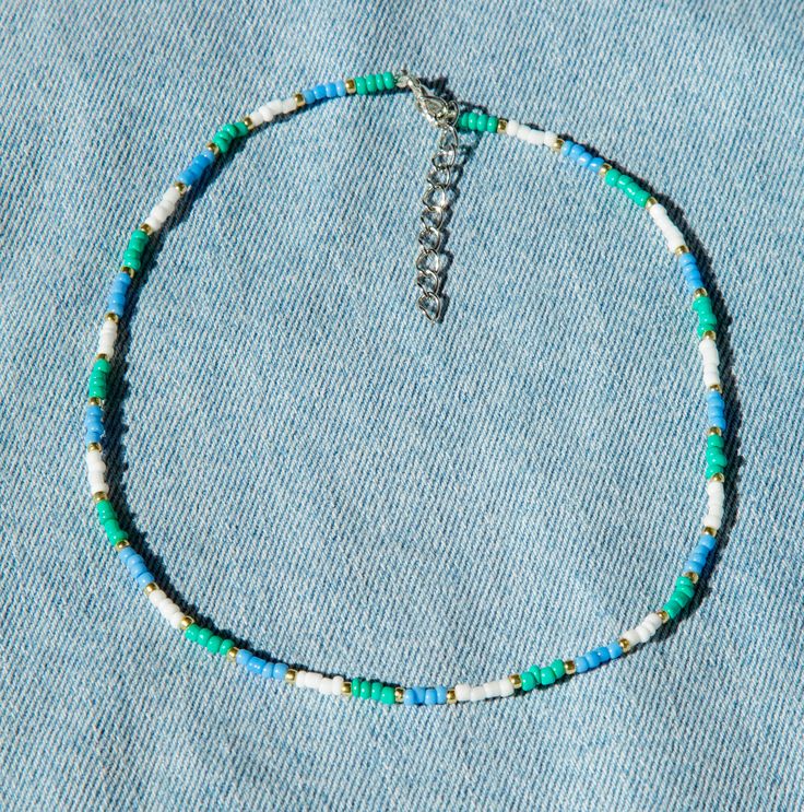 Seed Bead Choker Necklace, Trendy Blue Beaded Choker, Trendy Blue Choker With Colorful Beads, Casual Turquoise Beaded Necklaces With Tiny Beads, Colorful Heishi Beads Choker Necklace, Blue Beaded Choker For Summer, Summer Blue Beaded Choker, Festival Letter Beads Choker Necklace, Casual Blue Choker With Colorful Beads