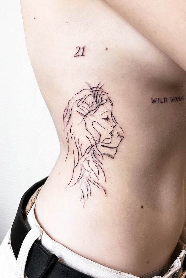 a woman's stomach with a small tattoo of a lion on her lower back