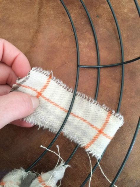 someone is cutting fabric with scissors on a wire rack that has been placed in place