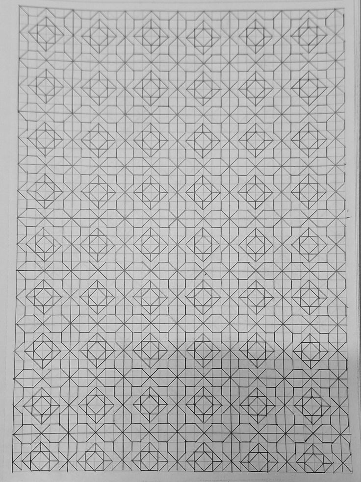 a black and white photo of an intricate design on the side of a sheet of paper