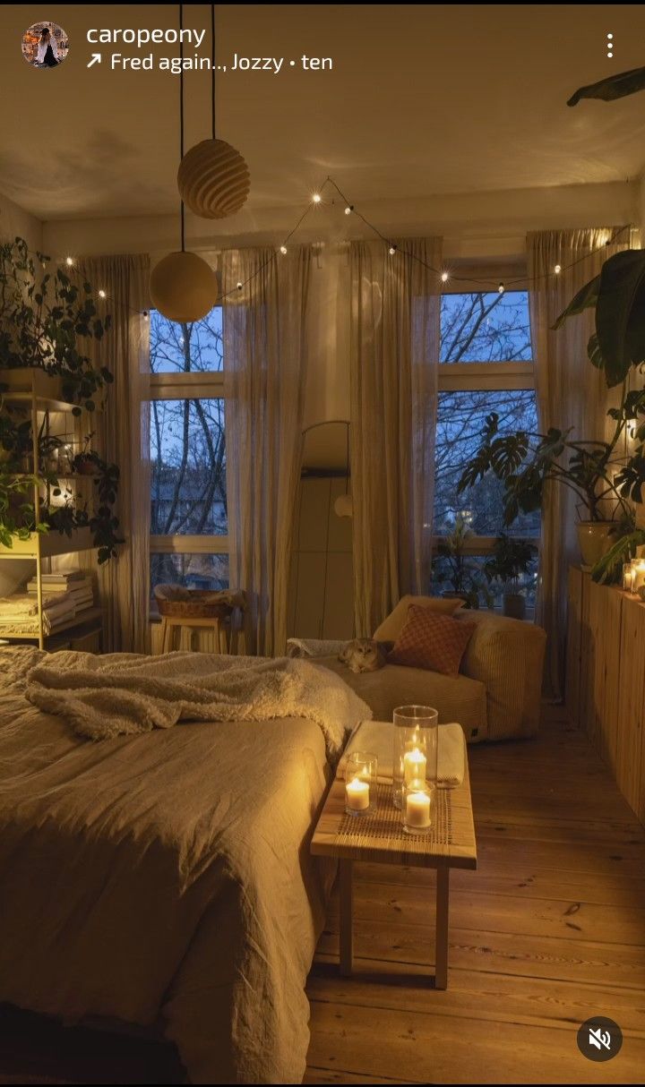 a bed room with a neatly made bed and candles