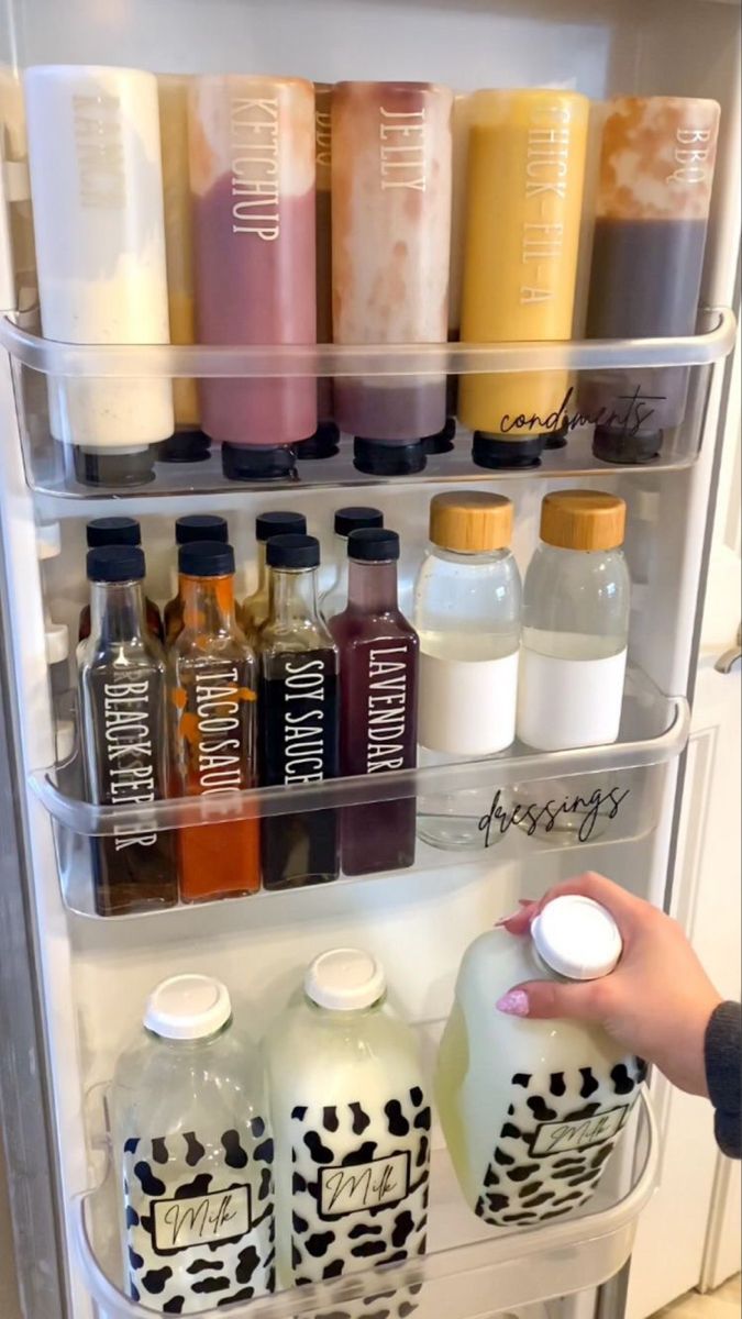 a refrigerator door is filled with bottles and containers