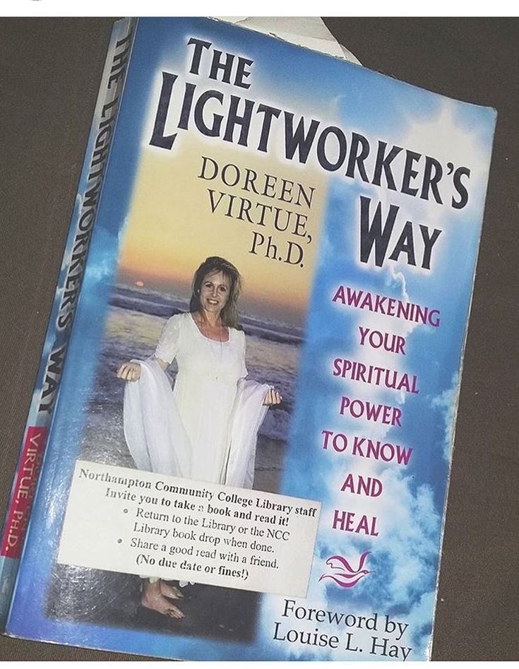 the lightworker's way book is open to show its cover and features an image of a woman in white