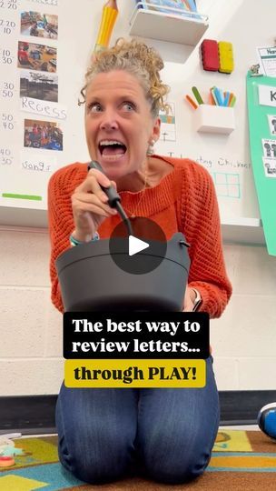 a woman is sitting on the floor with her mouth open and holding a microphone in front of her