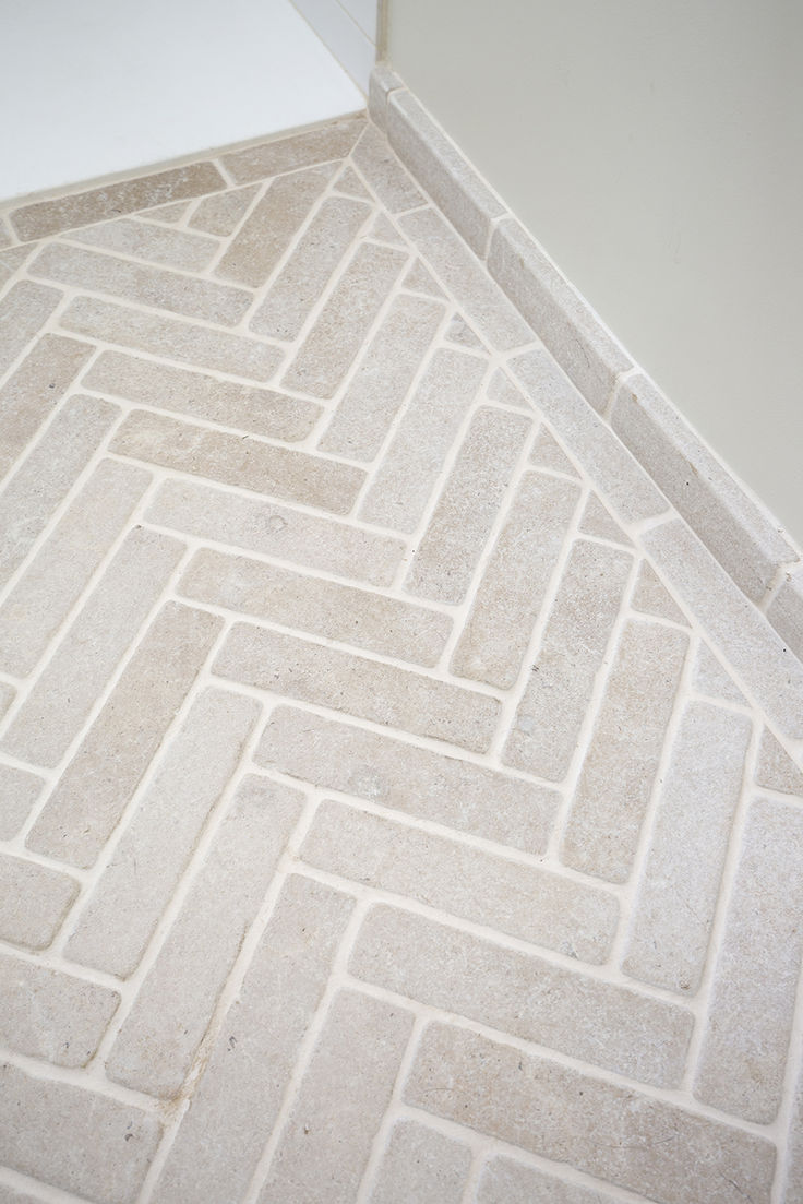 a white toilet sitting on top of a tiled floor