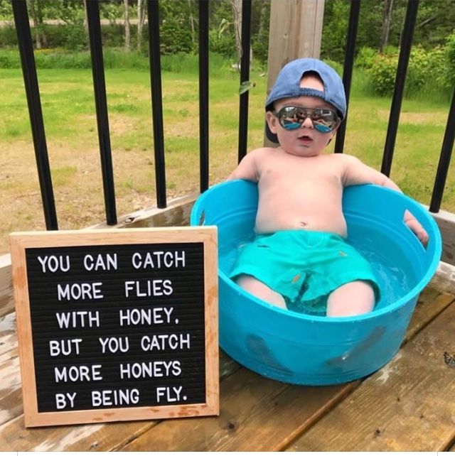 a baby sitting in a blue tub next to a sign that says, how i'm