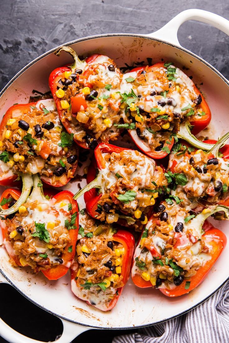 a pan filled with stuffed bell peppers covered in toppings