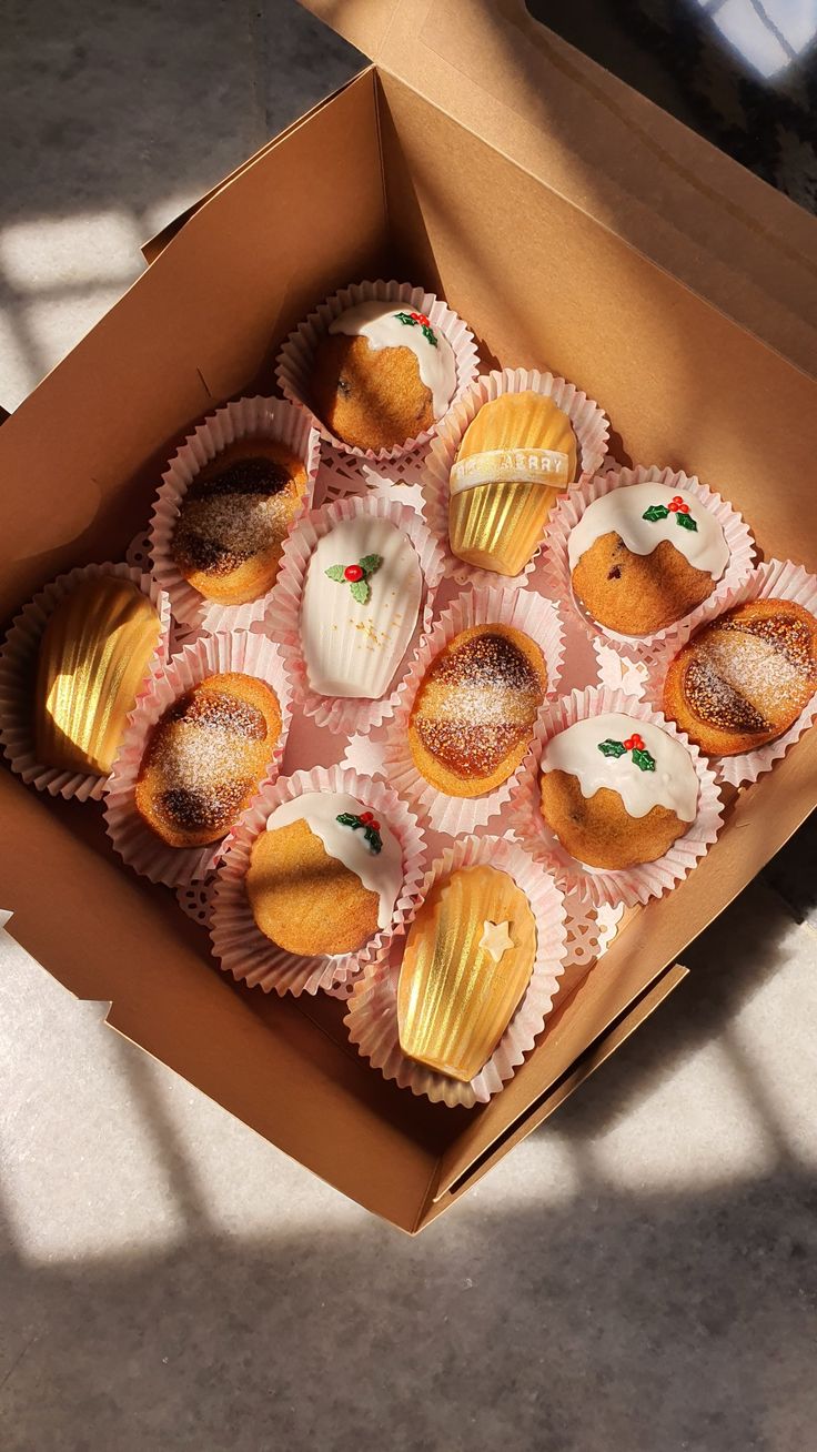 a box filled with cupcakes sitting on top of a table