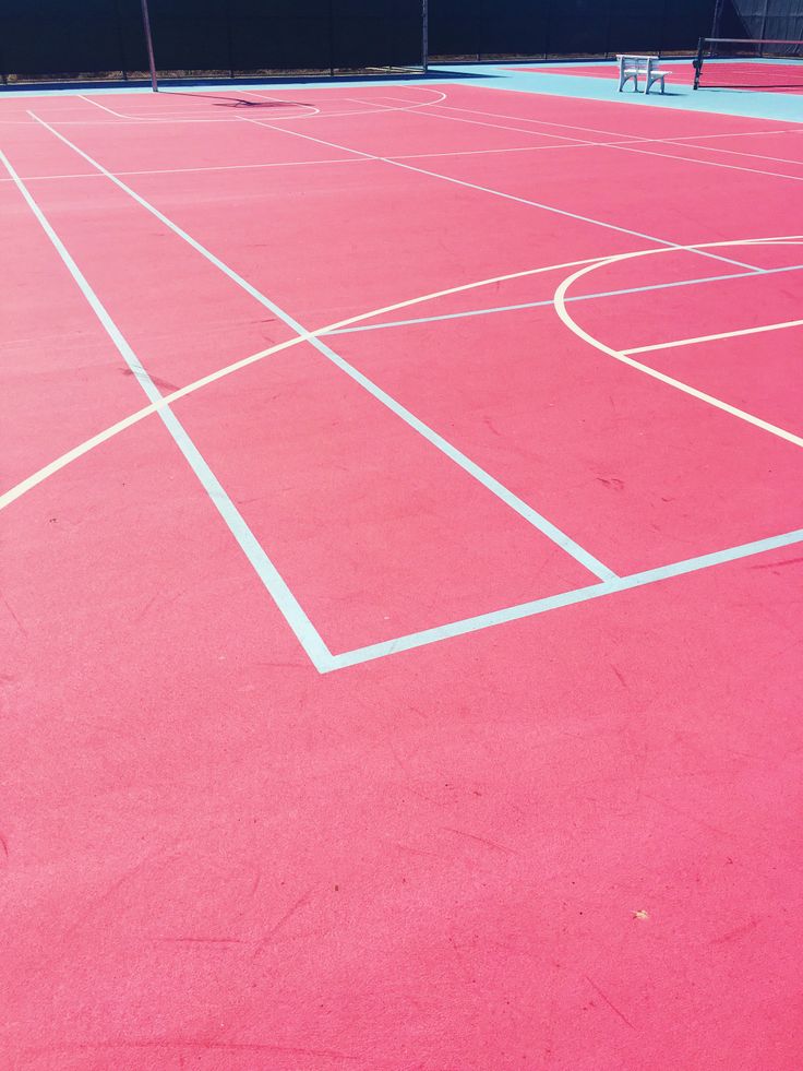 an empty tennis court with white lines painted on it