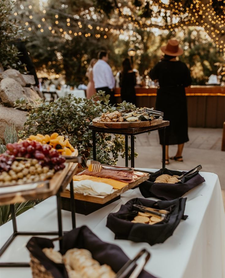 a buffet table with food and people in the background