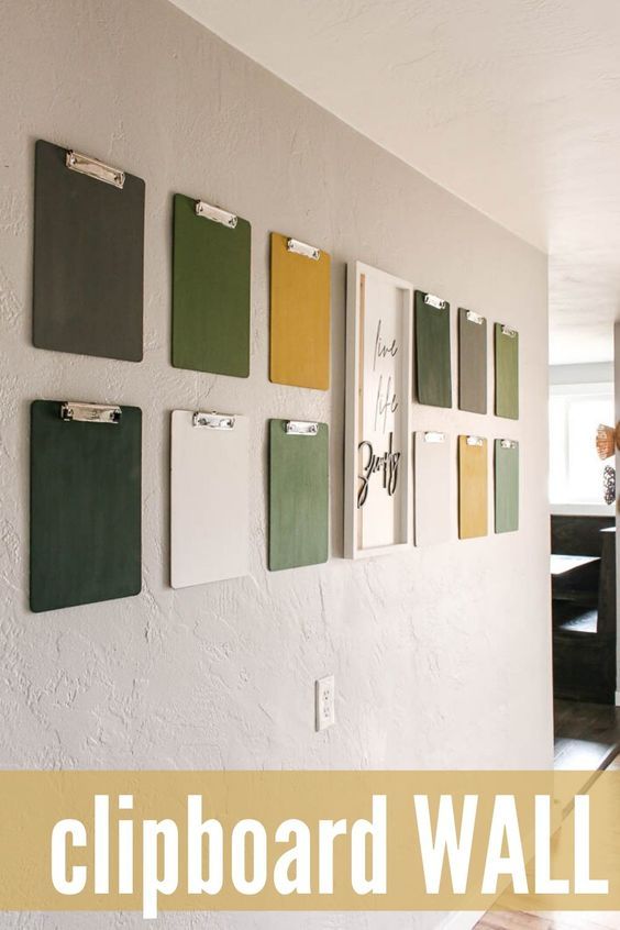 a wall with several clipboards on it and the words clipboard wall above them