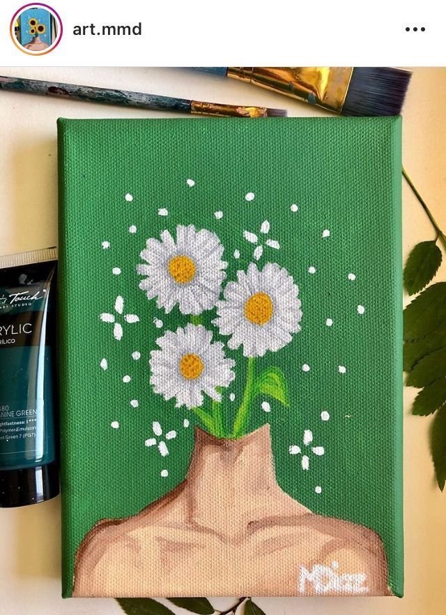 a painting with some flowers in it on a table next to a bottle of paint