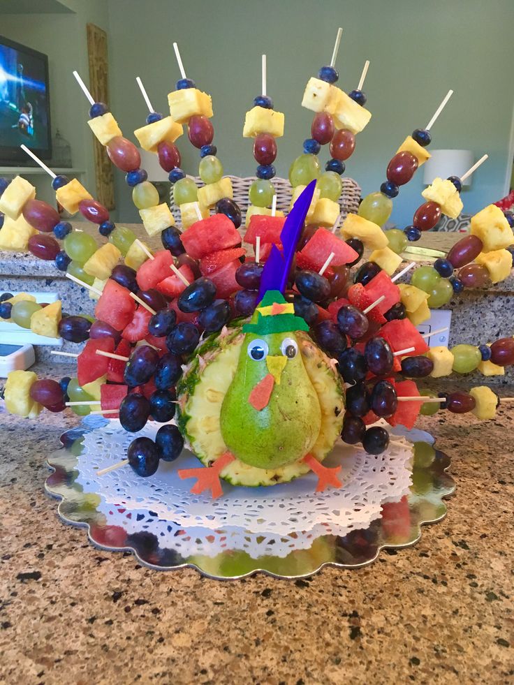 a turkey made out of fruit is sitting on a counter top with toothpicks sticking out of it's head