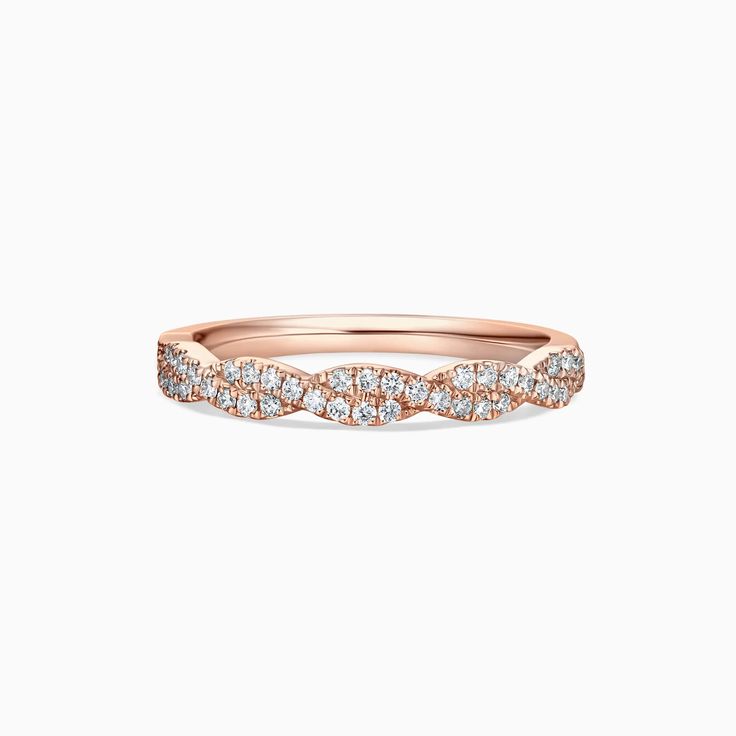 a rose gold wedding band with diamonds on the sides and an elegant twist in the middle