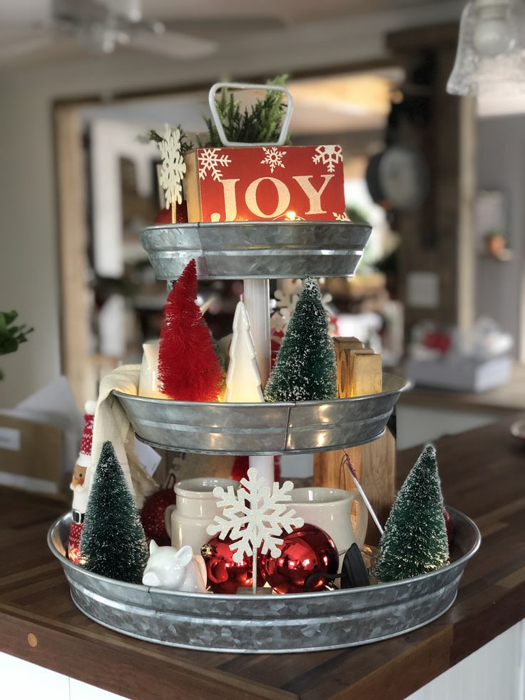 three tiered tray with christmas decorations on it