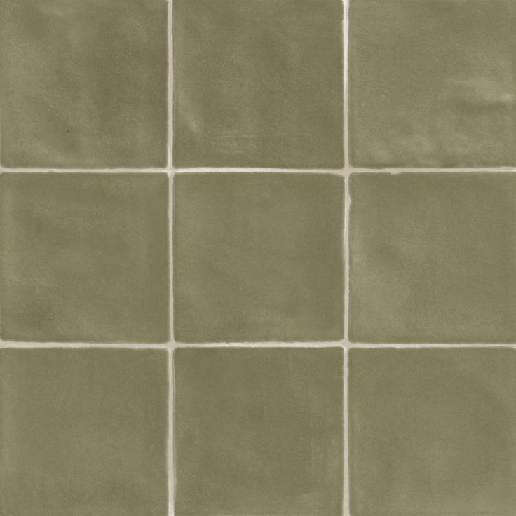 a green tile wall with white squares on it