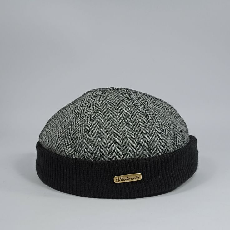 only size:56cm. Introducing the Docker cap, an exquisite and practical accessory made from the finest Harris Tweed fabric, which is made from 100% pure wool. Harris Tweed is renowned for its unrivalled quality amongst all wool fabrics. This cap has been carefully designed to provide a comfortable fit around the ears, with a cotton lining and sweatband at the top for extra comfort. To accentuate its uniqueness, the crown is elegantly finished with a ribbed hem. Inspired by the iconic style of the Adjustable Herringbone Pattern Hat For Winter, Adjustable Herringbone Winter Hat, Adjustable Winter Hat With Herringbone Pattern, Black Herringbone Pattern Flat Cap, Adjustable Tweed Hat For Winter, Classic Adjustable Tweed Hat, Adjustable Tweed Cap, Classic Black Hat With Herringbone Pattern, Adjustable Brimmed Hat With Herringbone Pattern