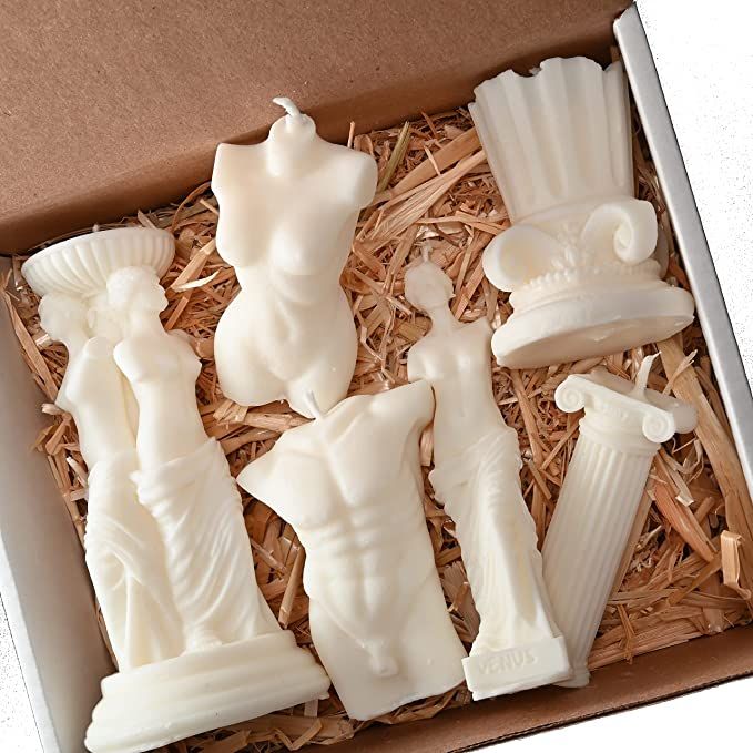 a box filled with white plastic figurines sitting on top of straw