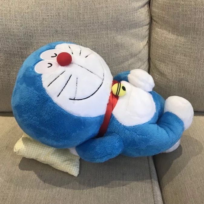 a blue stuffed animal laying on top of a couch