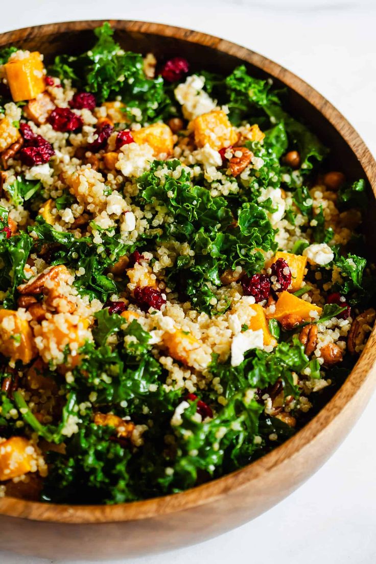 a wooden bowl filled with lots of food