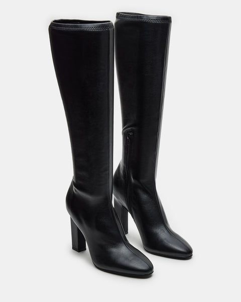 Elevate your style with our ARIA knee-high heeled boot. Crafted with a sleek design, these boots will add a touch of sophistication to any outfit. You can confidently step out in style with a comfortable heel height and secure fit. Perfect for any fashion-forward individual. 4 inch heel height Size 6 measurements: 13.5 Elegant Tall Boots For Work, Elegant Tall Boots For Workwear, Elegant Tall Heeled Boots For Work, Elegant Tall Heeled Boots For Workwear, Sleek High Shaft Boots For Workwear, Elegant Tall Knee-high Winter Boots, Elegant Wide Calf Tall Boots, Elegant Tall Knee-high Boots For Workwear, Workwear High Shaft Heeled Boots