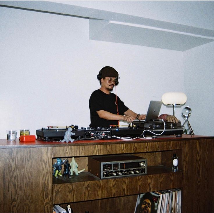 a man that is sitting at a dj's desk