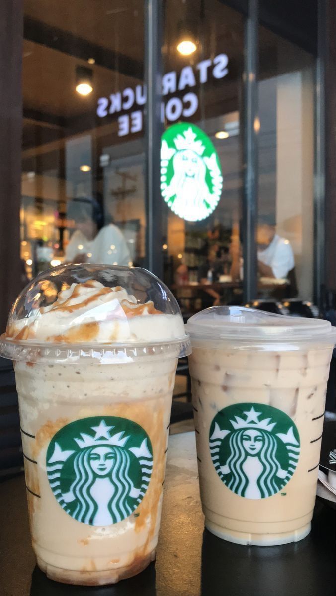 two starbucks drinks sitting next to each other on a table