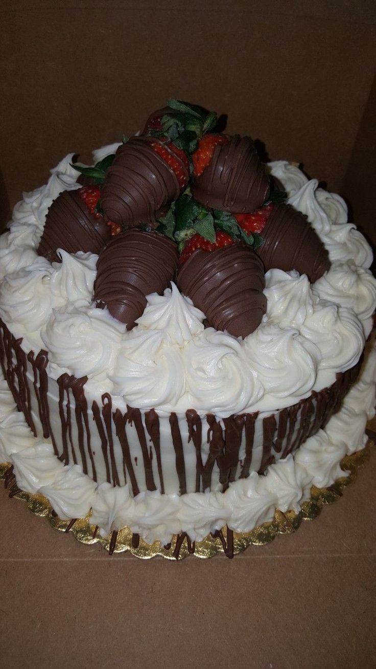 a chocolate covered cake with strawberries on top