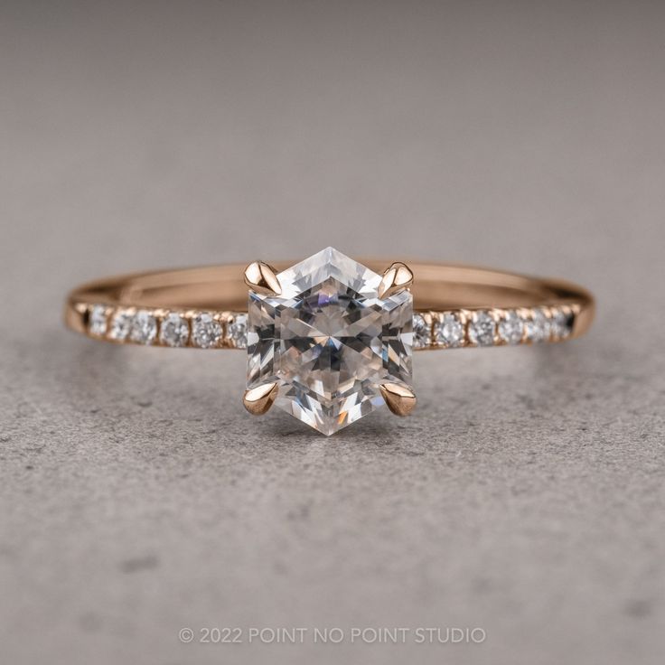 an engagement ring with a cushion cut diamond in the center