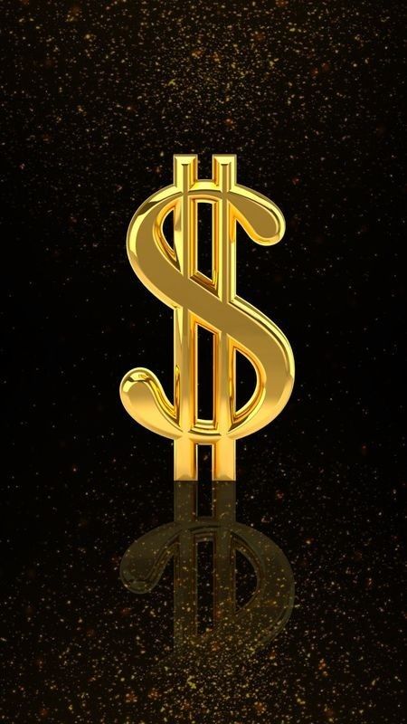 a golden dollar sign sitting on top of a black surface with gold flecks