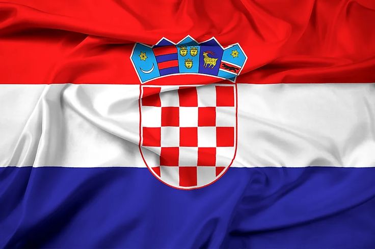 the flag of croatia is flying in the wind with an emblem on it's chest