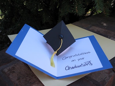 a graduation cap and tassel on top of an open card with congratulations written on it