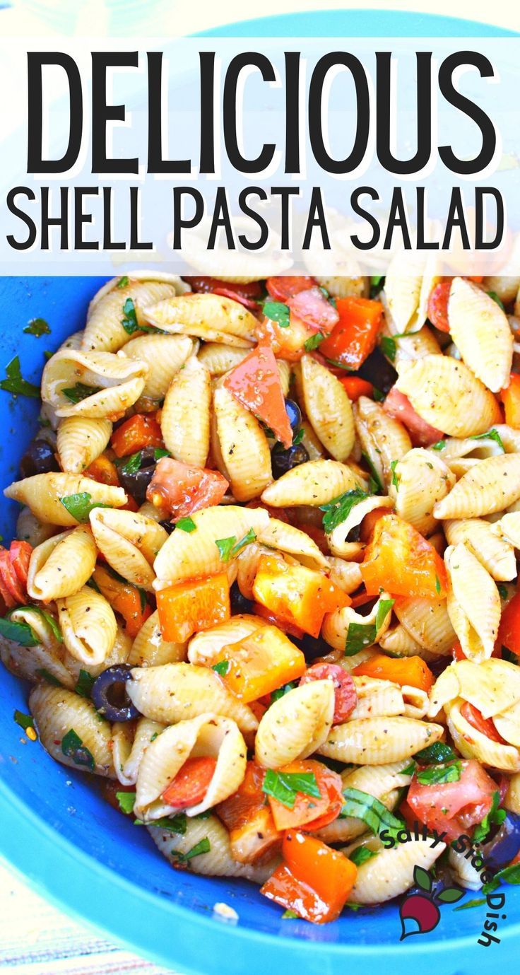 a blue bowl filled with pasta salad on top of a table