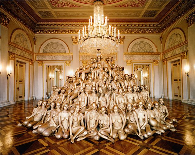 a large sculpture in the middle of a room with chandelier