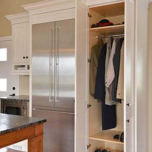 an open closet with clothes hanging on it