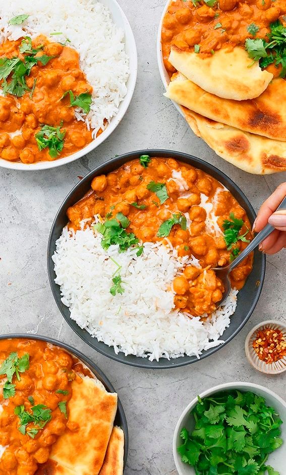 the meal is prepared and ready to be eaten on the table, including rice, beans and naan bread