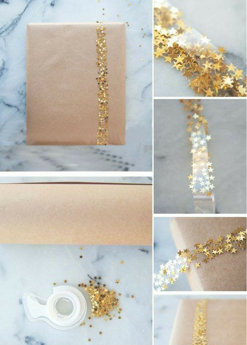 gold and white wrapping paper is being used to wrap the gift bags with glitters