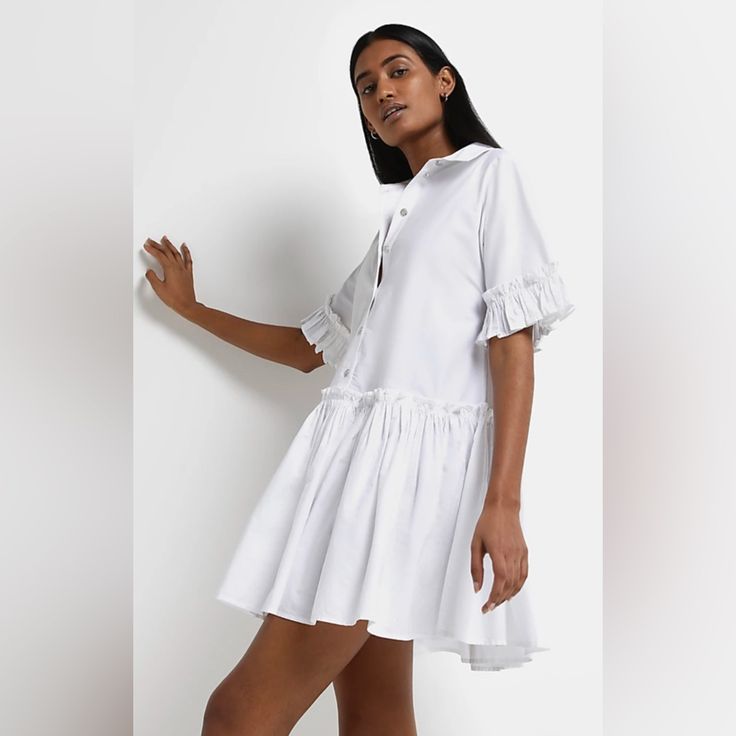 Frill Detail Tiered Hem Button Front Fastenings Short Sleeves Mini Length Chic Cotton Shirt Dress With Ruffles, Feminine Cotton Shirt Dress For Day Out, Cotton Button-up Shirt Dress With Ruffles, Cotton Ruffled Button-up Shirt Dress, Feminine Ruffled Shirt Dress For Daywear, Fitted Ruffled Shirt Dress For Daywear, Collared Cotton Shirt Dress With Ruffles, Cotton Collared Shirt Dress With Ruffles, Casual Shirt Dress With Ruffle Hem For Spring