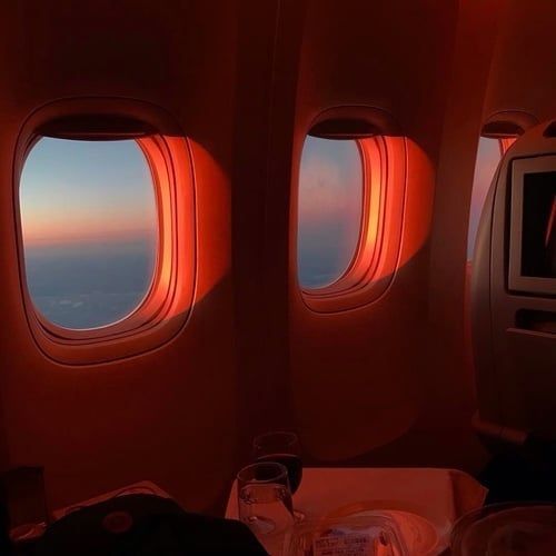 the view from inside an airplane window at sunset