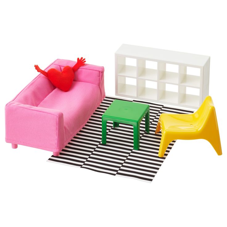 a pink couch and two small tables on top of a black and white striped rug