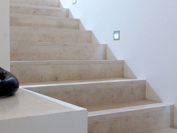 a remote control sitting on top of a set of stairs next to a stair case