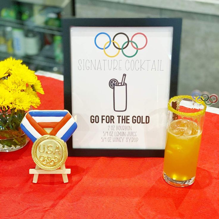 a table topped with drinks and medals on top of it