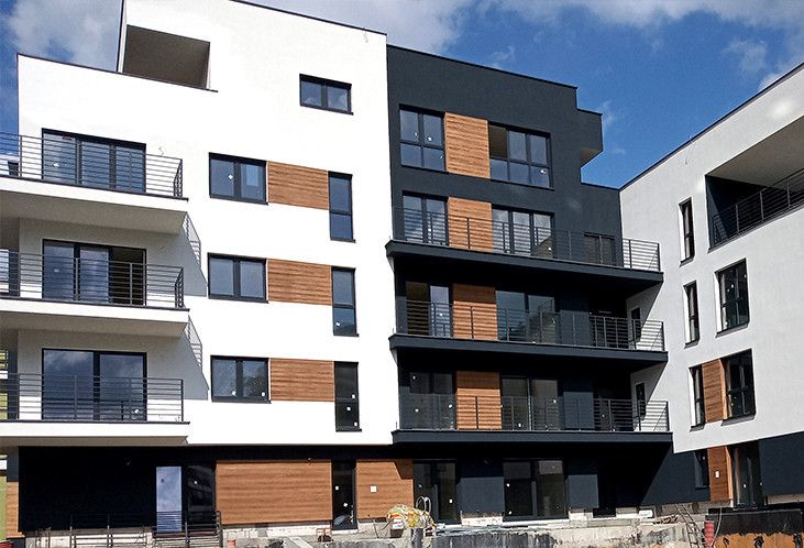 an apartment building with balconies on the second floor