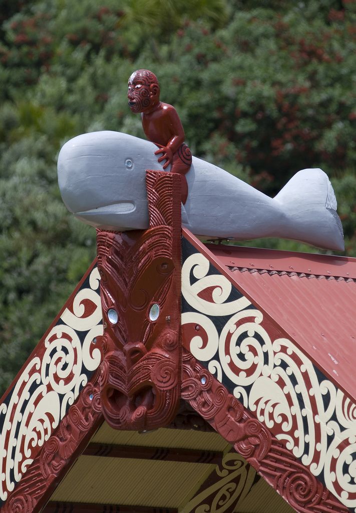 a red and white roof with a statue on top