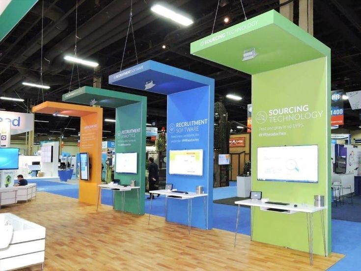 an exhibit room with various displays and people walking around