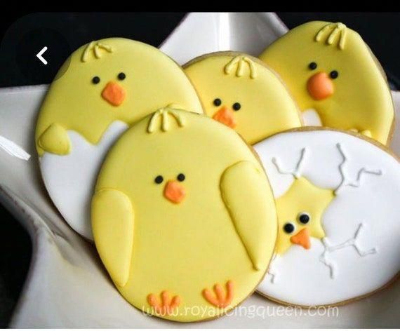 three decorated cookies in the shape of ducks