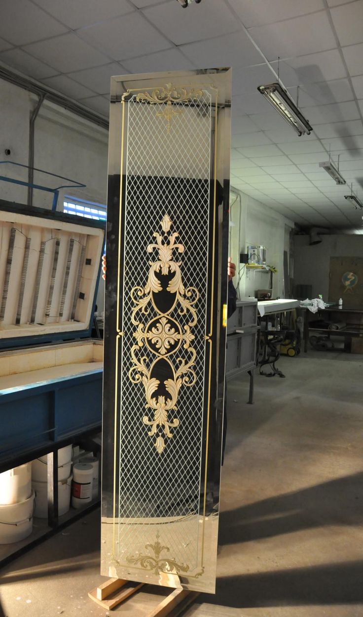 an ornately decorated metal door in a warehouse