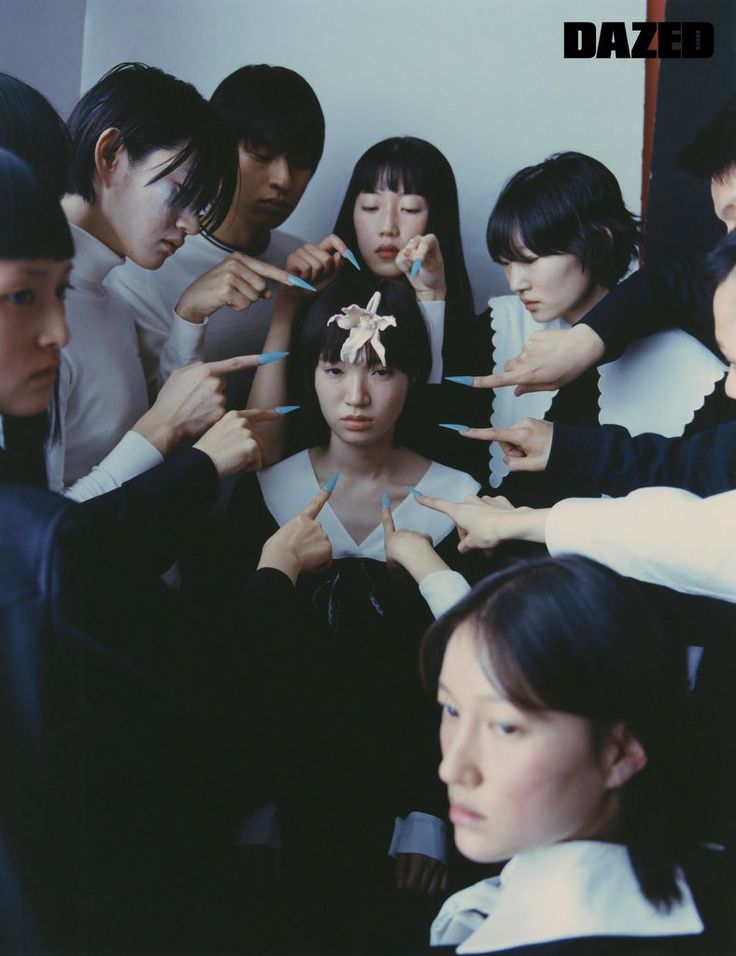 a group of people standing around each other brushing their hair