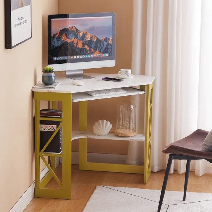 a computer monitor sitting on top of a desk next to a book shelf and chair