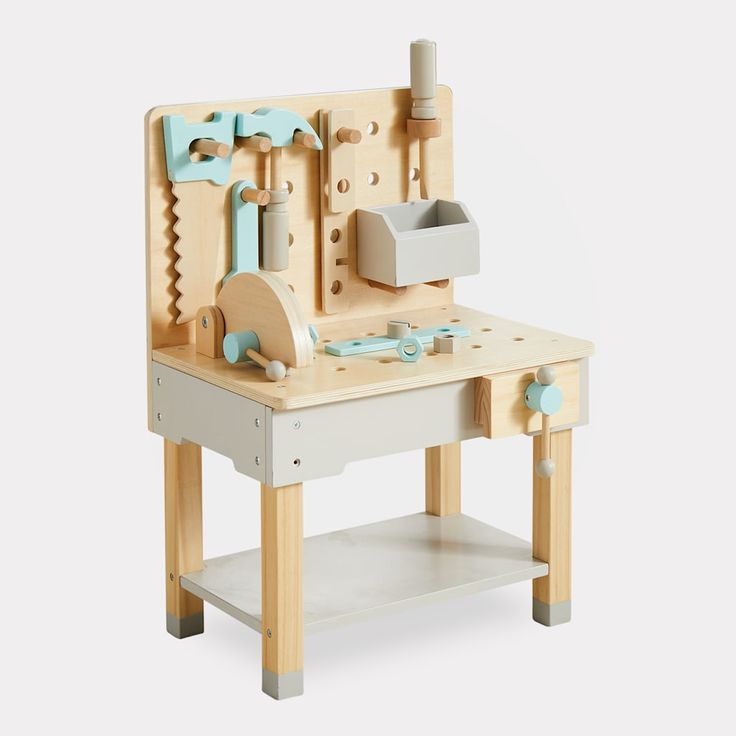 a wooden toy work bench with tools on it